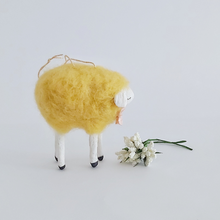 Cargar imagen en el visor de la galería, An opposite side view of a yellow, vintage style needle felted spun cotton sheep ornament. White flowers sit in front of her, against a white background. Pic 6 of 7. 
