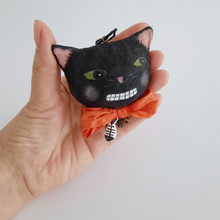 Load image into Gallery viewer, A vintage style, spun cotton black cat ornament held in a hand against a white background. Pic 2 of 6. 
