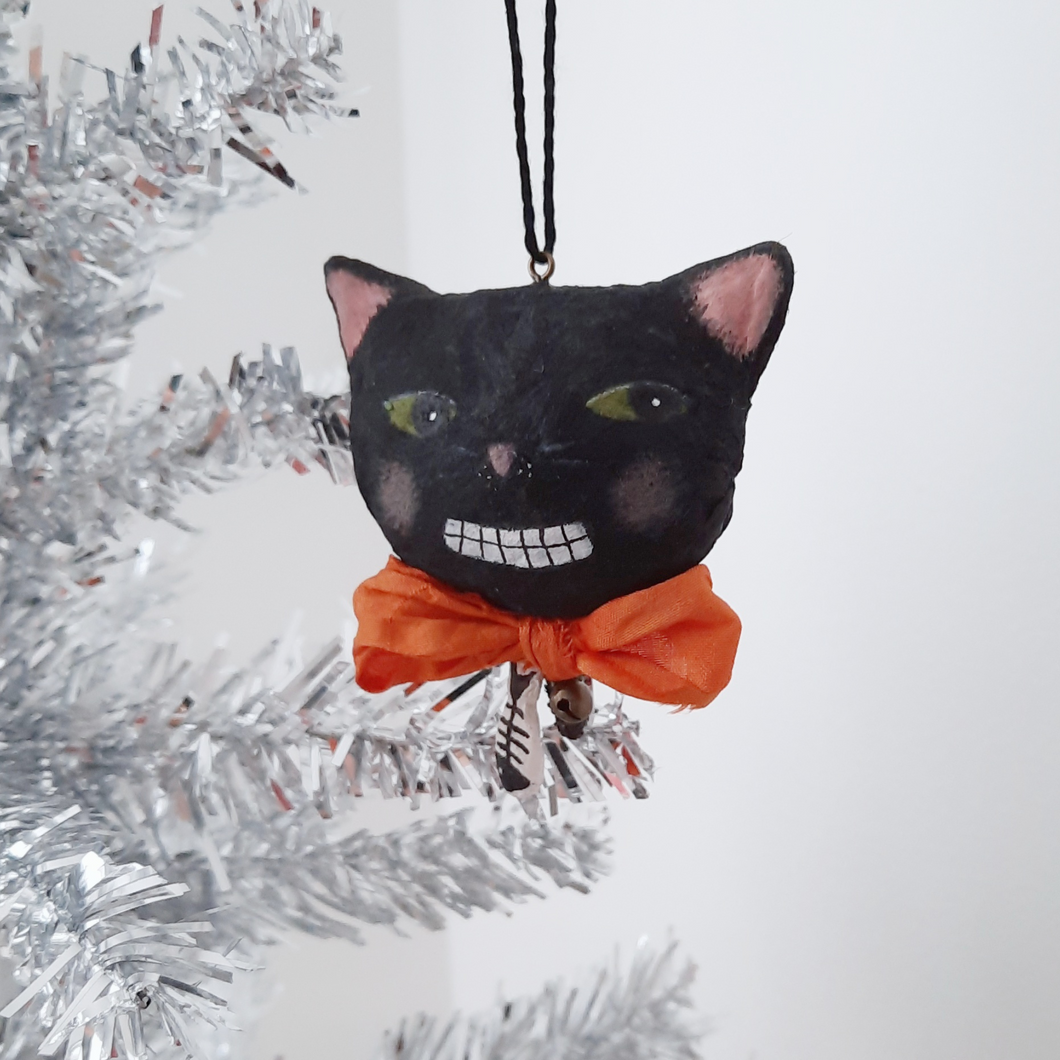 A vintage style, spun cotton black cat ornament hanging from a silver tree against a white background. Pic 1 of 6. 