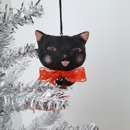 A vintage style spun cotton black cat ornament hanging from a tree, against a white background. Pic 1 of 7.