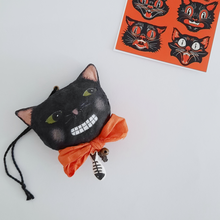 Cargar imagen en el visor de la galería, A vintage style, spun cotton black cat ornament laying by a print of an illustration of vintage black cats. Pic 6 of 6. 
