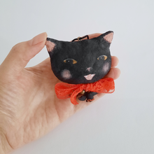 Load image into Gallery viewer, A vintage style, spun cotton black cat ornament held in a hand against  a white background. Pic 2 of 7. 
