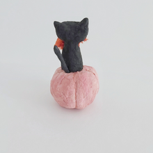 Load image into Gallery viewer, A back view of a vintage style spun cotton black cat, sitting in a pink pumpkin against a white background. Pic 7 of 7. 
