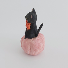 Load image into Gallery viewer, A side view of a vintage style spun cotton black cat sitting in a pink pumpkin, against a white background. Pic 6 of 7. 
