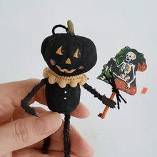 Load image into Gallery viewer, A close up view of a vintage style, spun cotton black pumpkin man ornament and the skeleton sign he&#39;s holding. Pic 3 of 7. 
