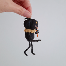 Load image into Gallery viewer, A side view of a vintage style, spun cotton black pumpkin man ornament. Pic 4 of 7. 
