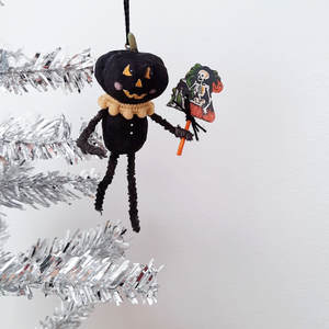 A vintage style, spun cotton black pumpkin man ornament hanging on a silver tree. Pic 1 of 7. 