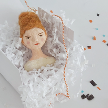 Load image into Gallery viewer, A vintage style spun cotton Bride of Frankenstein ornament laying in a white gift box on white shredded paper. The box sits on a white background covered in Halloween confetti. Pic 7 of 8. 

