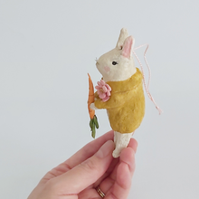 Load image into Gallery viewer, A side view of a vintage style spun cotton bunny ornament, held in hand against a white background. Pic 5 of 12. 
