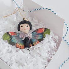 Cargar imagen en el visor de la galería, A vintage style spun cotton butterfly girl laying in a white gift box, on white tissue shredding. Pic 4 of 7. 
