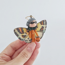 Load image into Gallery viewer, A vintage style, spun cotton Halloween butterfly girl held in a hand against a white background. Pic 2 of 7. 
