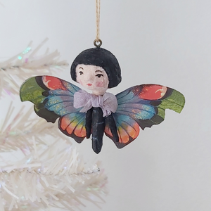 A vintage style spun cotton butterfly girl ornament hanging on a white tree. Pic 2 of 7. 