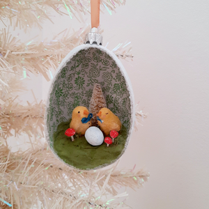 A vintage style, spun cotton chicks diorama ornament hanging on a white tree. Pic 2 of 7. 