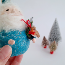 Load image into Gallery viewer, Hand holding a decorative gnome with a small robin and trees in the background
