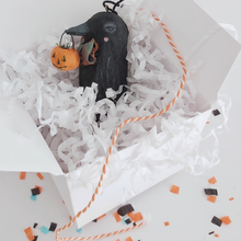 Load image into Gallery viewer, A vintage style spun cotton crow ornament laying in a white gift box filled with white tissue shredding. The box sits on a white background with Halloween confetti. Pic 8 of 8. 
