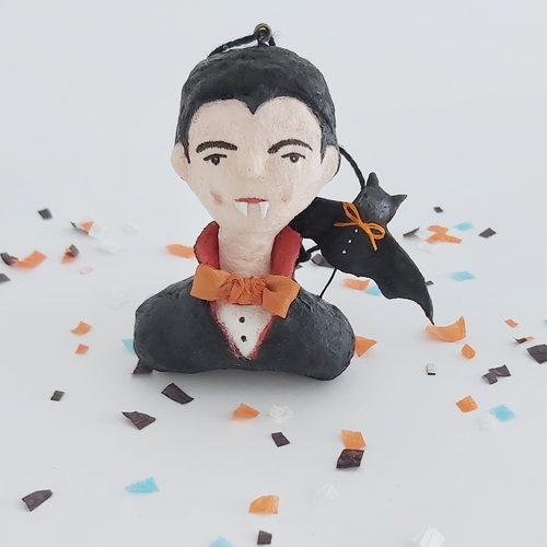 Vintage style spun cotton dracula ornament sitting on Halloween confetti against a white background. Pic 1 of 8. 