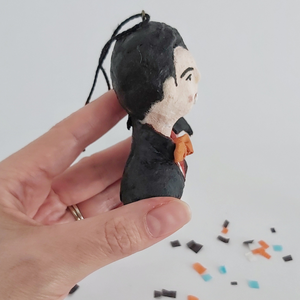 A side view of a vintage style spun cotton Dracula ornament, against a white background. Pic 6 of 8. 