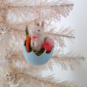 A vintage style, spun cotton Easter bunny ornament hanging on a white tree. Pic 3 of 8. 