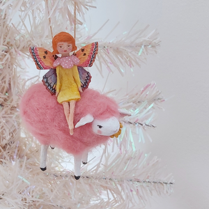 A vintage style, spun cotton fairy on sheep ornament hanging on a white tree. Pic 2 of 7. 