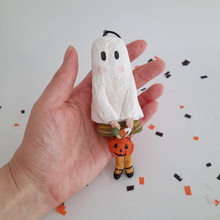 Load image into Gallery viewer, A vintage style, spun cotton ghost girl ornament held in hand  over confetti against a white background. Pic 2 of 7. 
