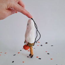 Load image into Gallery viewer, A side view of a vintage style, spun cotton ghost girl ornament against a white background on Halloween confetti. Pic 5 of 7. 
