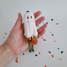 Load image into Gallery viewer, A hand holding a vintage style, spun cotton ghost girl ornament against a white background. Pic 2 of 8. 
