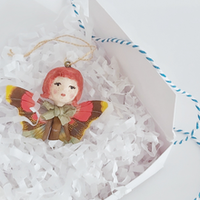 Load image into Gallery viewer, Vintage style spun cotton ginger butterfly girl laying in a white gift box on white shredded tissue. Pic 4 of 7.
