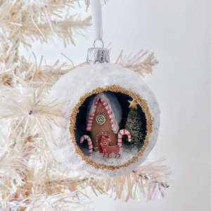 A vintage style spun cotton gingerbread diorama ornament hanging on a white tree. Pic 2 of 6. 