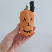 Load image into Gallery viewer, A vintage style spun cotton jack-o-lantern and crow ornament, held in hand against a white background. Pic 2 of 8. 
