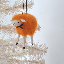 Load image into Gallery viewer, An orange, vintage style spun cotton needle felted sheep ornament hanging on a white tree. Pic 3 of 5. 
