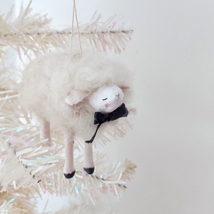 A white, spun cotton needle felted sheep ornament hanging from a white tree. Pic 2 of 6. 