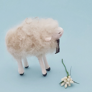 Side view of a vintage style spun cotton needle felted sheep ornament, against a light blue background. Pic 4 of 6. 