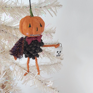 A vintage style spun cotton pinecone pumpkin man hanging in tree against a white background. Pic 3 of 8. 