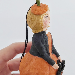 A closer view of spun cotton pumpkin girl ornament. Pic 3 of 9. 