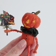 Load image into Gallery viewer, A vintage style, spun cotton pumpkin man ornament held in a hand against a white background. Pic 1 of 8. 
