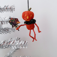 Load image into Gallery viewer, Another photo of a vintage style, spun cotton pumpkin man ornament hanging from a silver tree. Pic 7 of 8. 
