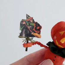 Load image into Gallery viewer, A close-up of a vintage witch illustration held by a spun cotton pumpkin man ornament. Pic 4 of 8.
