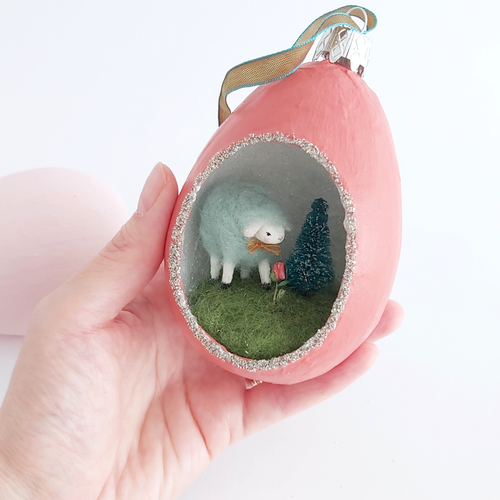 A vintage style, spun cotton sheep diorama ornament held in hand against a white background. Pic 1 of 6. 