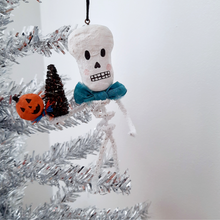 Load image into Gallery viewer, A vintage style, spun cotton pipe cleaner skeleton hanging on a silver tree. Pic 4 of 4. 
