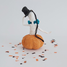 Load image into Gallery viewer, A back view of a vintage style, spun cotton skeleton in a jack-o-lantern. It&#39;s sitting on Halloween confetti against a white background. Pic 7 of 7. 
