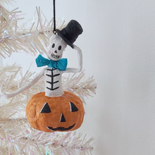Load image into Gallery viewer, A vintage style, spun cotton skeleton in a jack-o-lantern hanging from a tree. Pic 3 of 7. 
