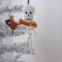 Load image into Gallery viewer, A vintage style, spun cotton pipe cleaner skeleton hanging from a silver tree. Pic 2 of 4. 
