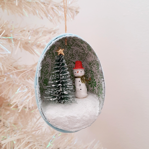A vintage style, spun cotton snowman diorama ornament hanging from a white Christmas tree. Pic 4 of 6. 