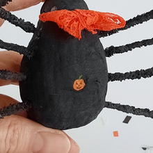 Load image into Gallery viewer, A close-up of a tiny jack-o-lantern painted on the torso of the spun cotton spider. Pic 4 of 8. 
