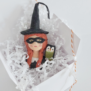 Vintage style spun cotton witch girl ornament laying in a white gift box on white tissue shredding. Pic 9 of 9. 