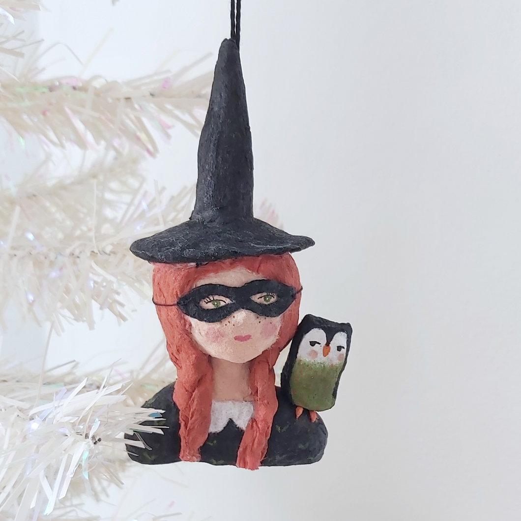 A vintage style spun cotton witch ornament hanging on a tree, against a white background. Pic 1 of 9. 