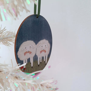 A vintage style, wooden sheep ornament hanging on a white tree. Pic 2 of 6