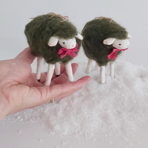 Vintage style woolly spun cotton green sheep, held in hand against a white background. Pic 2 of 7. 