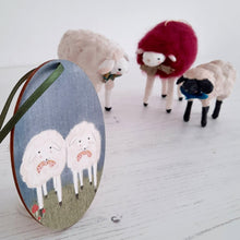 Cargar imagen en el visor de la galería, An image of a wooden sheep ornament with three spun cotton sheep in the distance. Pic 4 of 6.
