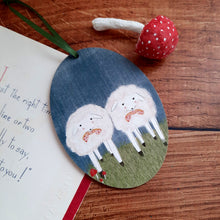 Cargar imagen en el visor de la galería, A wooden sheep ornament laying on a  dark wood background, next to a vintage card and red spun cotton mushroom. 
